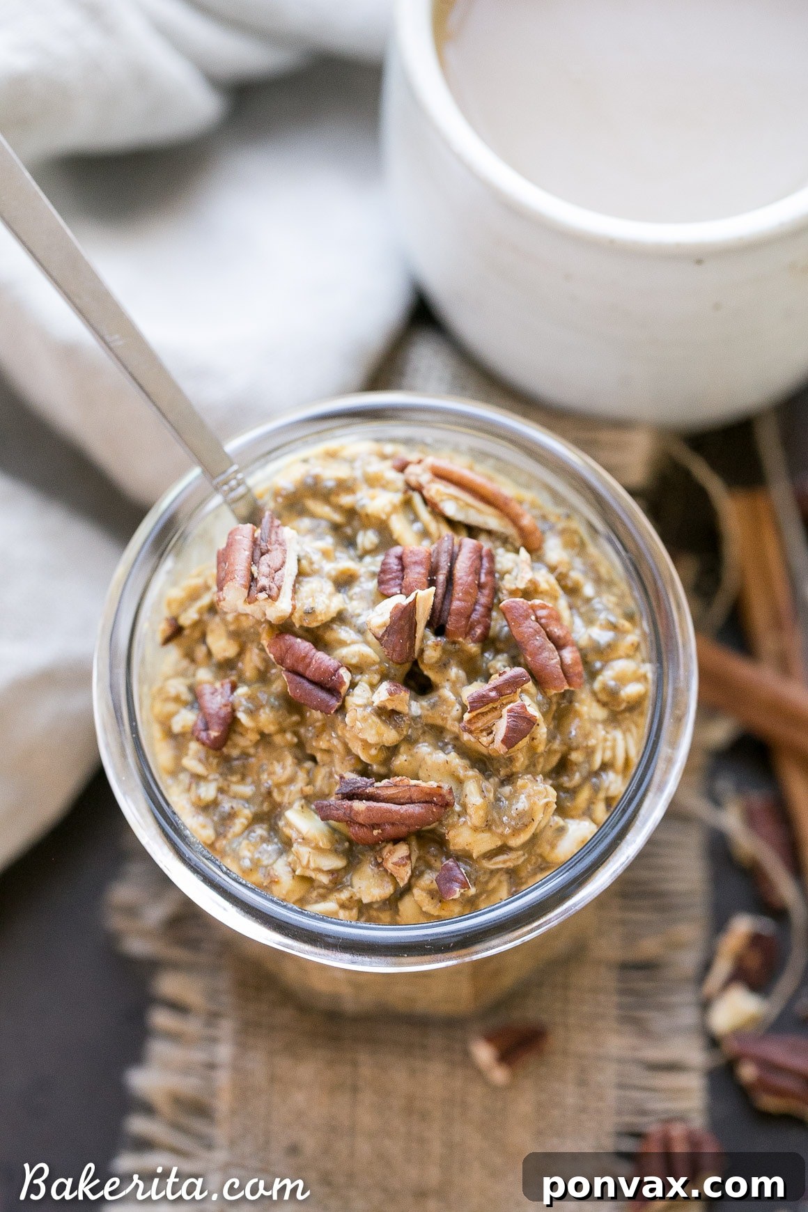 Autumn Spiced Latte Overnight Oats 5 Two jars of Pumpkin Spice Latte Overnight Oats garnished with toasted pecans, ready to enjoy.