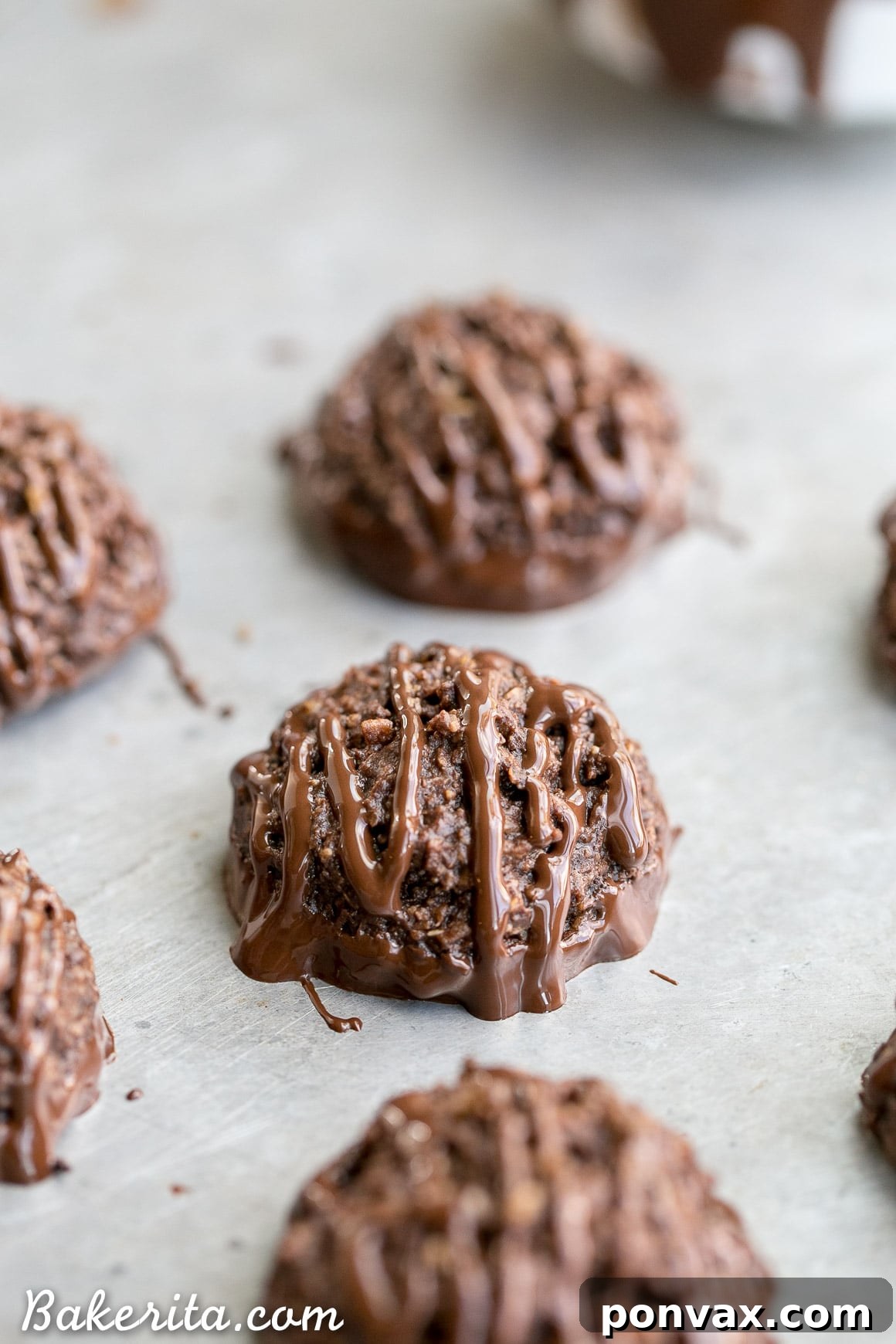Close-up of a stack of Double Chocolate Macaroons, showcasing their dark, rich color and chocolate drizzle, perfect for vegan and gluten-free diets.