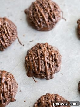 Rich Double Chocolate Macaroons, made super chocolatey with both cocoa powder and melted chocolate. These easy cookies are dipped and drizzled with chocolate, and they're gluten-free, Paleo + vegan.