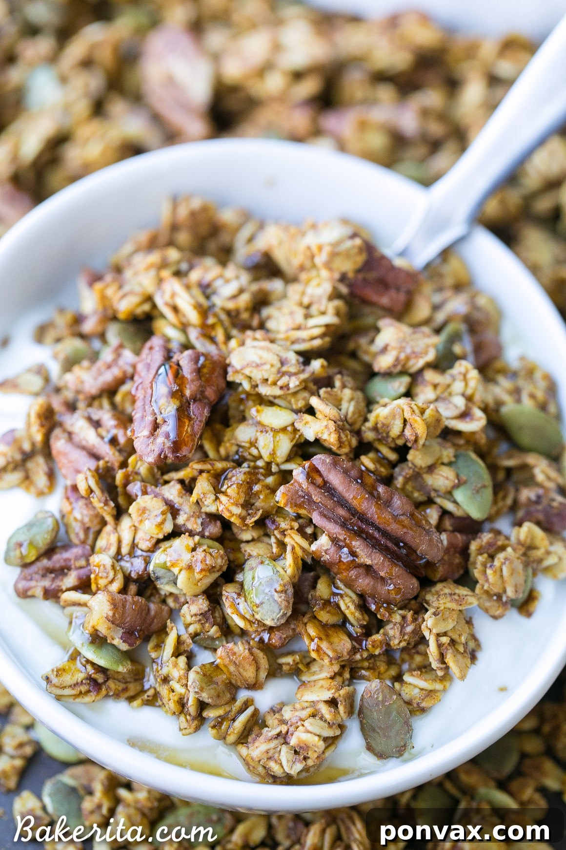 Delicious Pumpkin Granola cooling on parchment paper, ready to be broken into large, satisfying clusters.