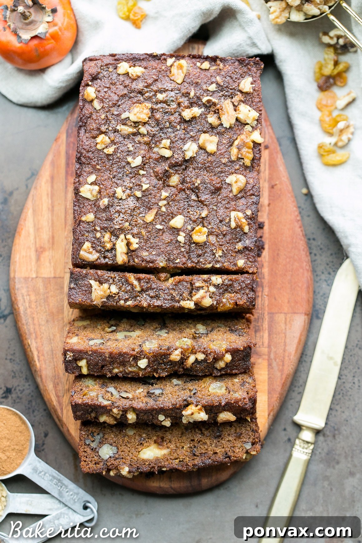A slice of moist Paleo Persimmon Bread with walnuts and raisins, perfect for a healthy breakfast or snack.