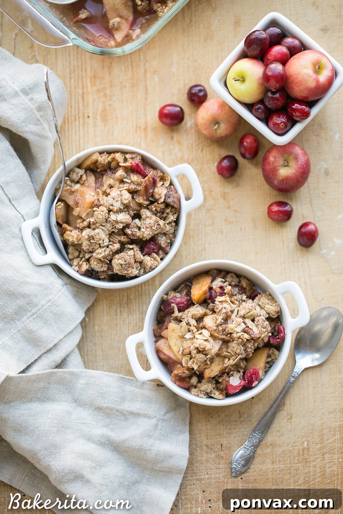 A vibrant Cranberry Apple Crisp, spiced with cinnamon, nutmeg, and orange zest, topped with a crunchy pecan oatmeal crisp, perfect for a gluten-free and vegan holiday dessert.