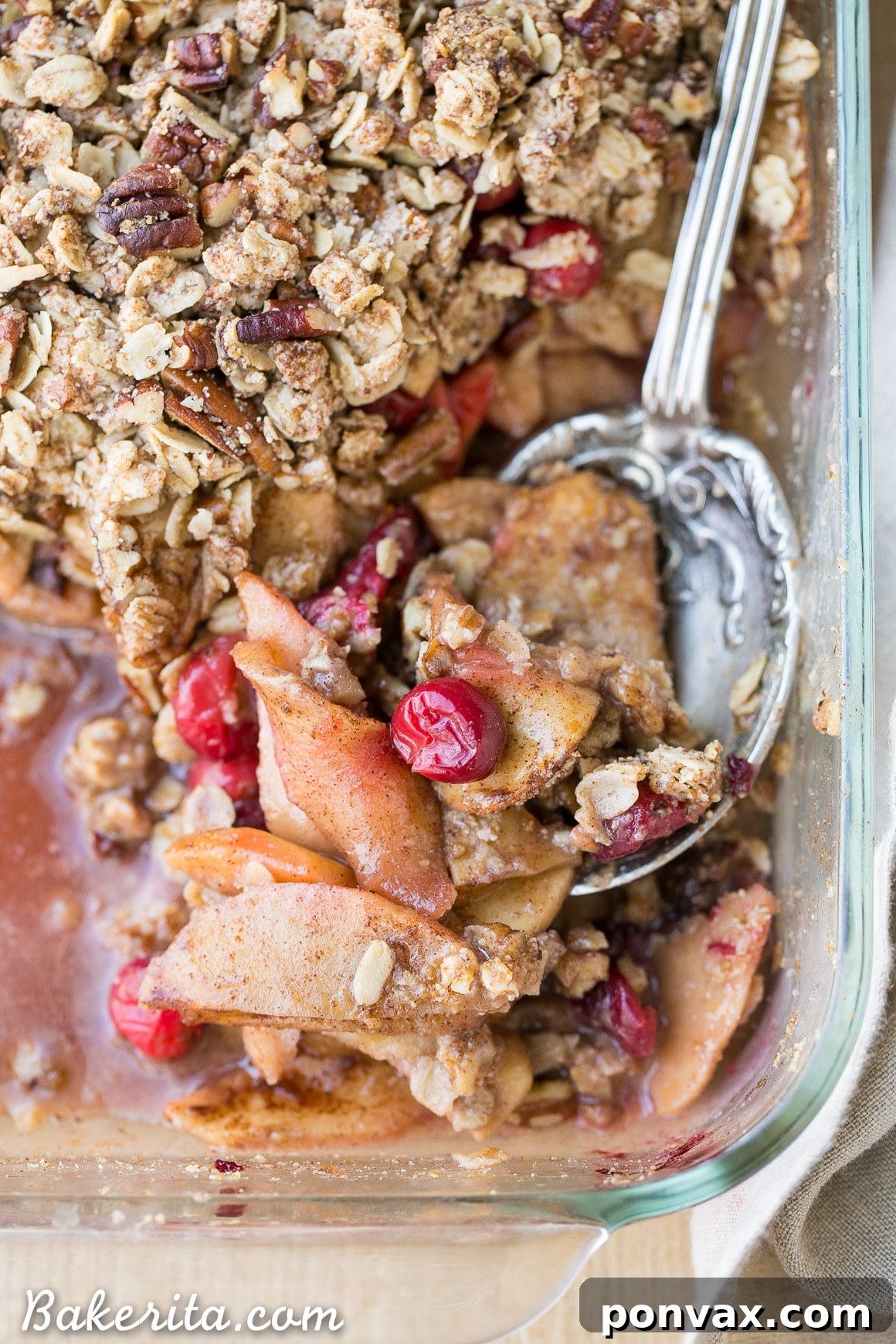 A generous serving of Cranberry Apple Crisp, showcasing its appealing texture and festive colors, ready to be enjoyed.