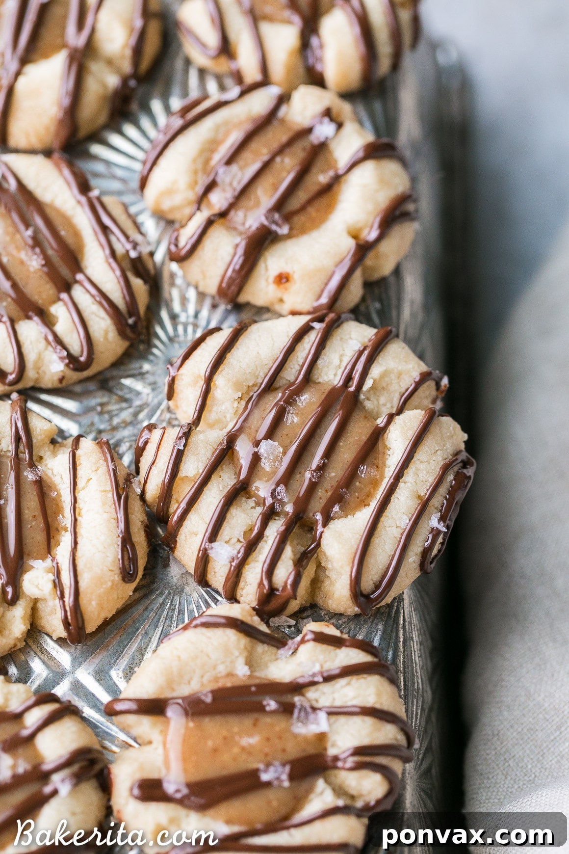 Decadent Gluten Free Salted Caramel Thumbprint Bites 3 These Salted Caramel Thumbprint Cookies are super easy to make with only 6 ingredients total! The tender gluten-free and Paleo shortbread cookies are filled with a no-cook vegan caramel and topped off with a dark chocolate drizzle and flaky sea salt. They're perfect for the holidays!