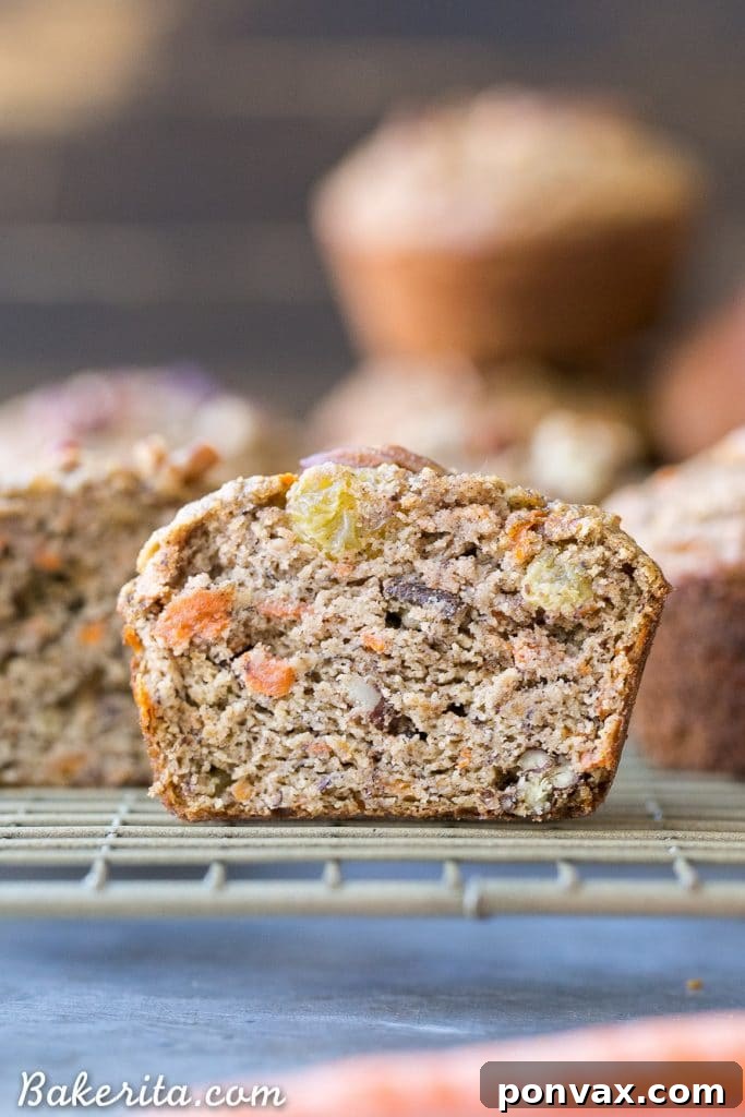 Wholesome Paleo Morning Glory Muffins 4 A pair of freshly baked Paleo Morning Glory Muffins, emphasizing their golden-brown tops and wholesome appearance, perfect for a nutritious breakfast.