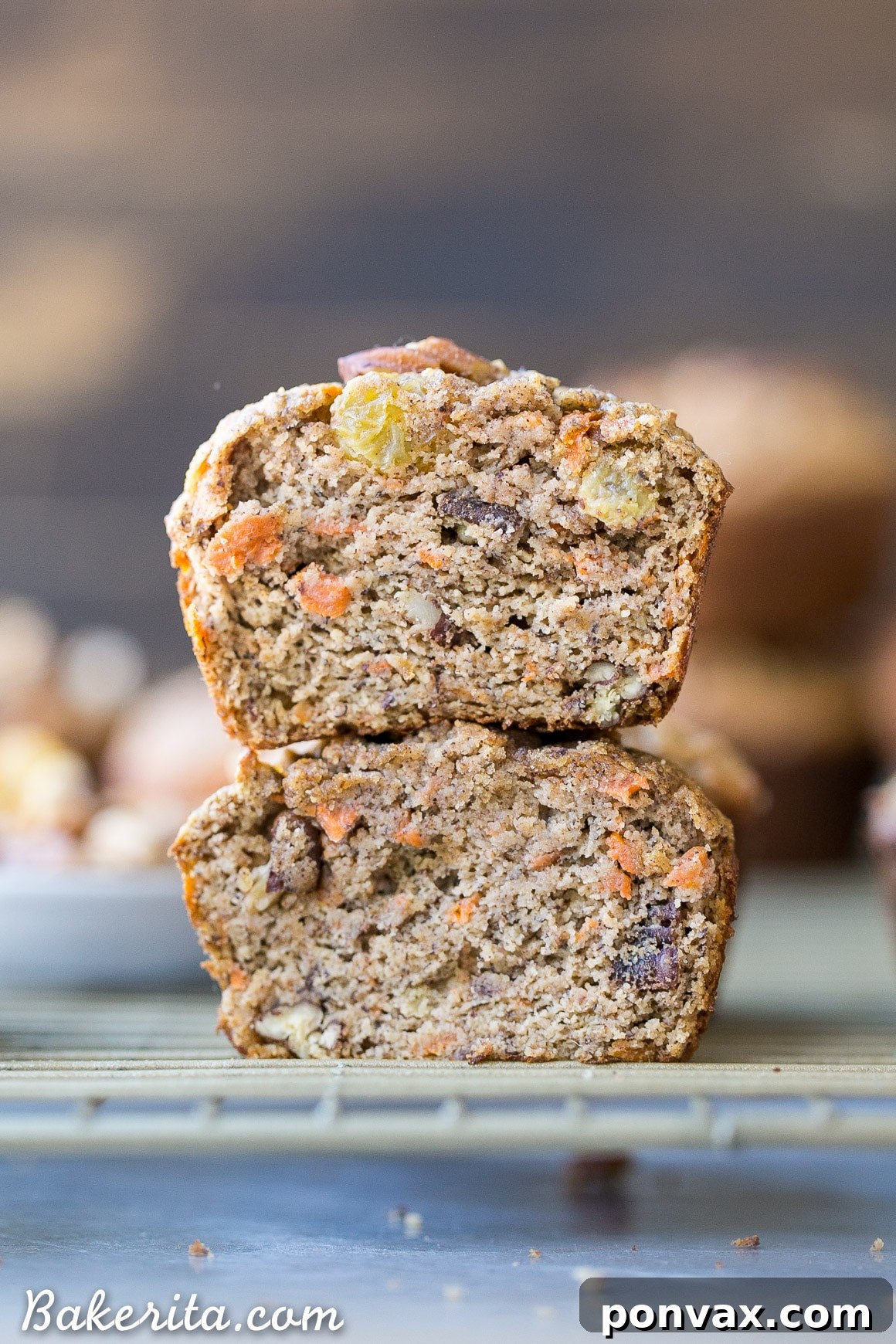 Wholesome Paleo Morning Glory Muffins 5 A close-up of a Paleo Morning Glory Muffin, split in half to reveal its moist, dense texture and the generous distribution of healthy ingredients like carrots, nuts, and raisins.