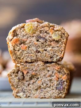 These Paleo Morning Glory Muffins are loaded with bananas, shredded carrots, toasted walnuts, and golden raisins. These easy muffins have NO added sugar - they're sweetened entirely with bananas! They're the perfect on-the-go breakfast or snack.