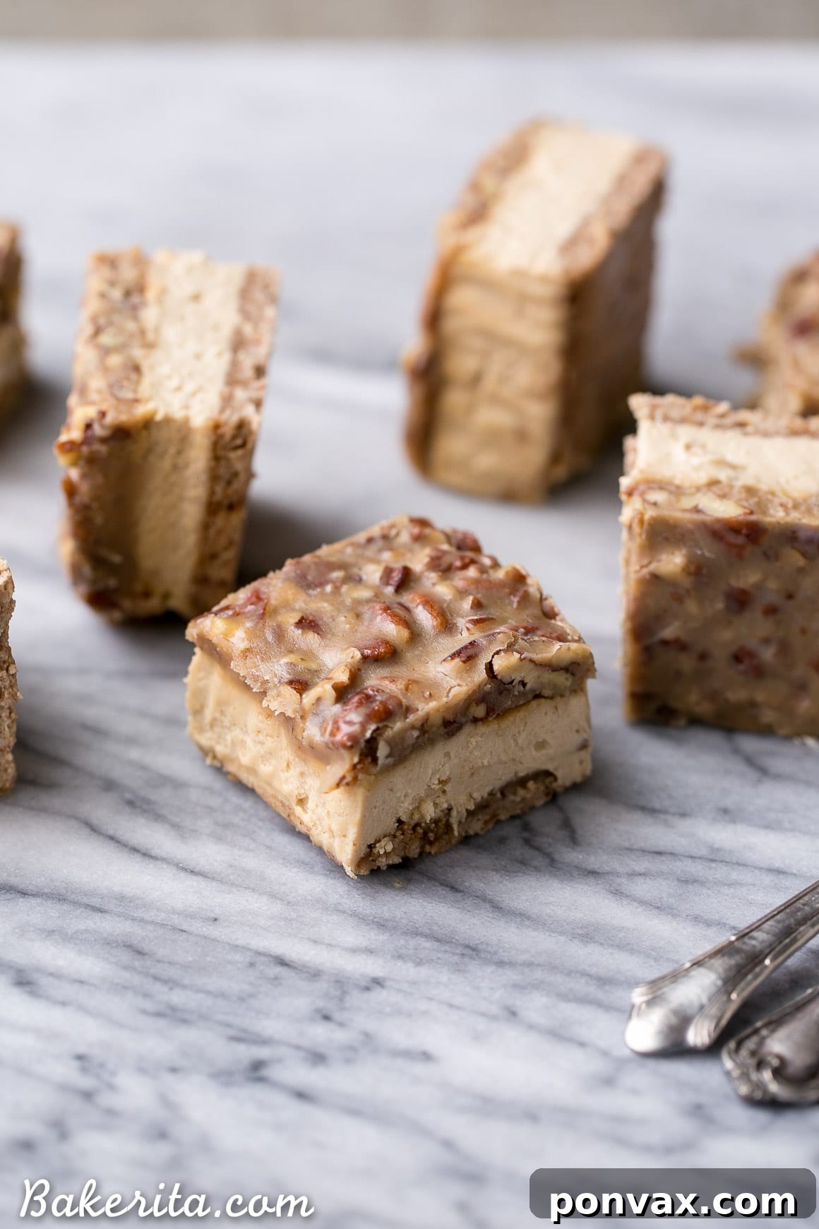 Close-up of a single slice of Pecan Praline Cheesecake Bar showcasing the creamy filling and caramel pecan topping