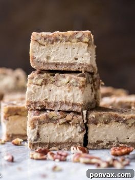 Final plated Gluten Free Pecan Praline Cheesecake Bars with a generous layer of crunchy topping