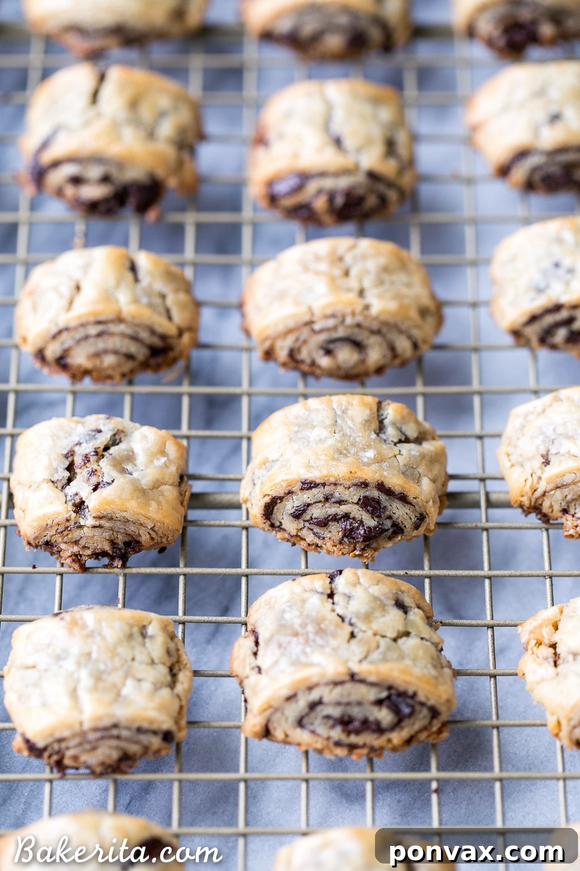 A plate piled high with tender and flaky chocolate rugelach, highlighting their refined sugar-free and gluten-free nature, a perfect wholesome dessert.