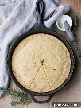 This Gluten Free Asiago Rosemary Cornbread is an easy, savory cornbread that's moist and flavorful. A slice of this gluten-free cornbread is perfect with a slather of butter or served with a bowl of soup!