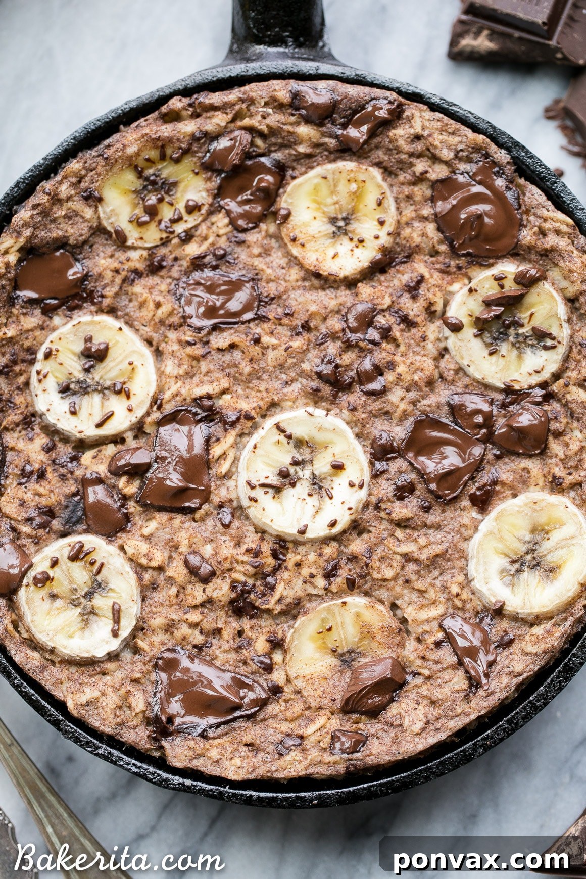 A delicious slice of warm Chocolate Chunk Banana Baked Oatmeal, revealing gooey melted chocolate and soft, tender oats. Ideal for a comforting morning meal.