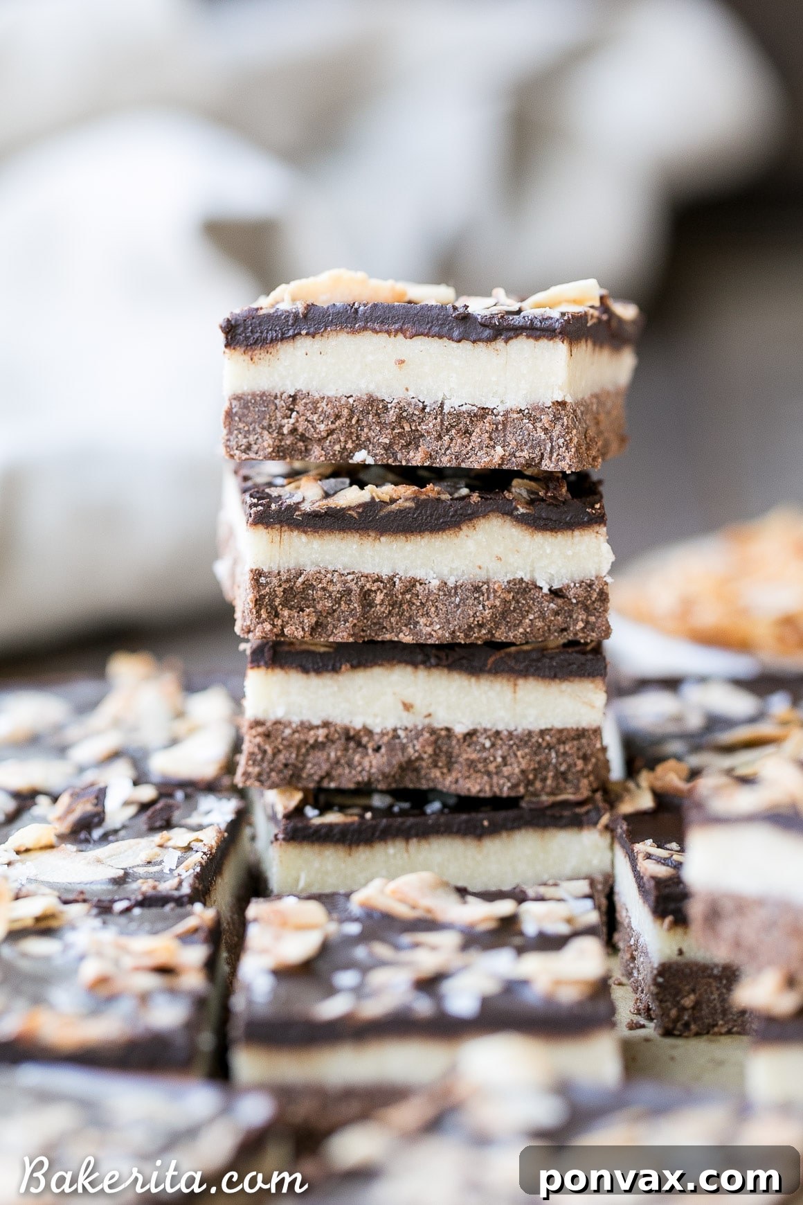 Gourmet gluten-free chocolate coconut bars, stacked high and ready to serve, perfect for a healthy dessert.