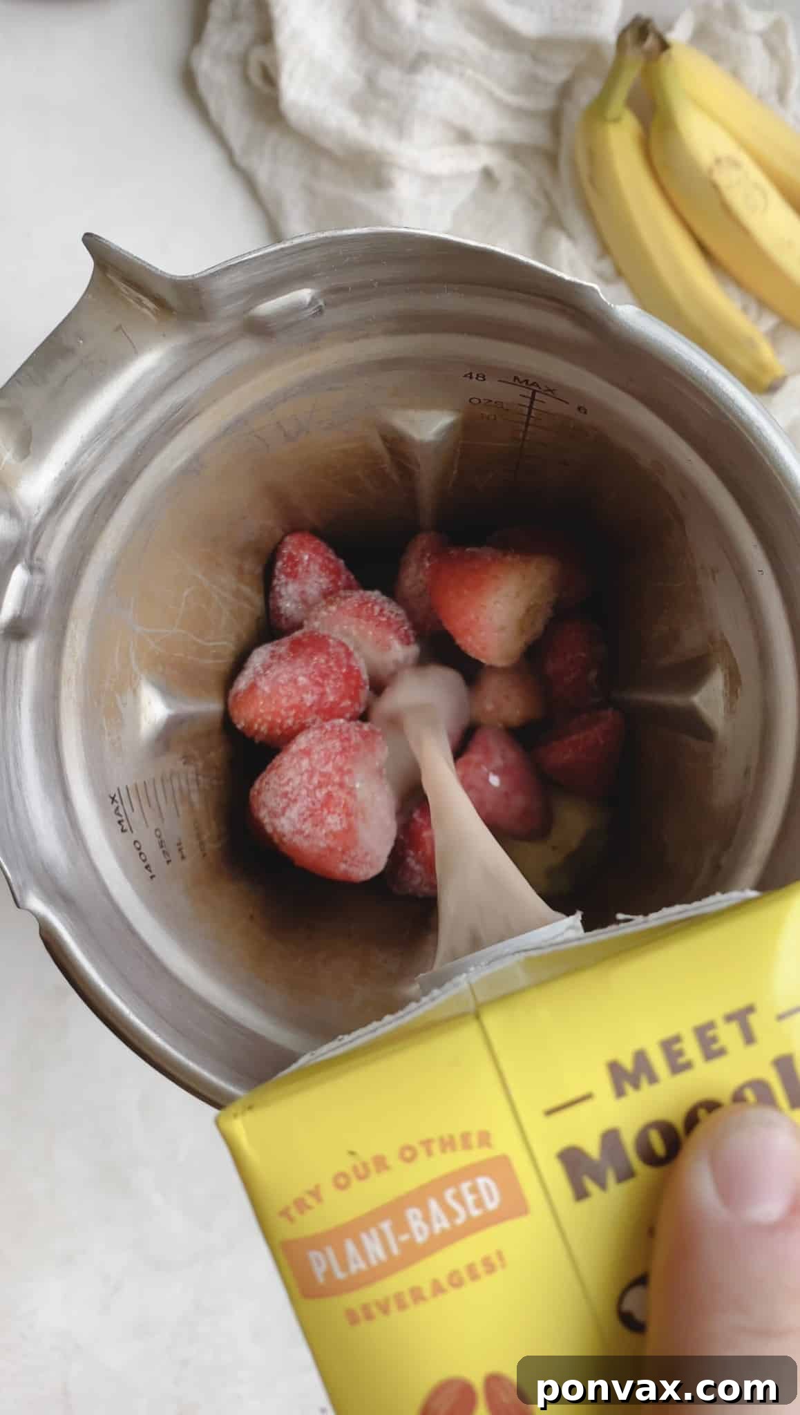 Raw ingredients for Strawberry Banana Smoothie Bowl: frozen strawberries, frozen banana, and coconut milk.