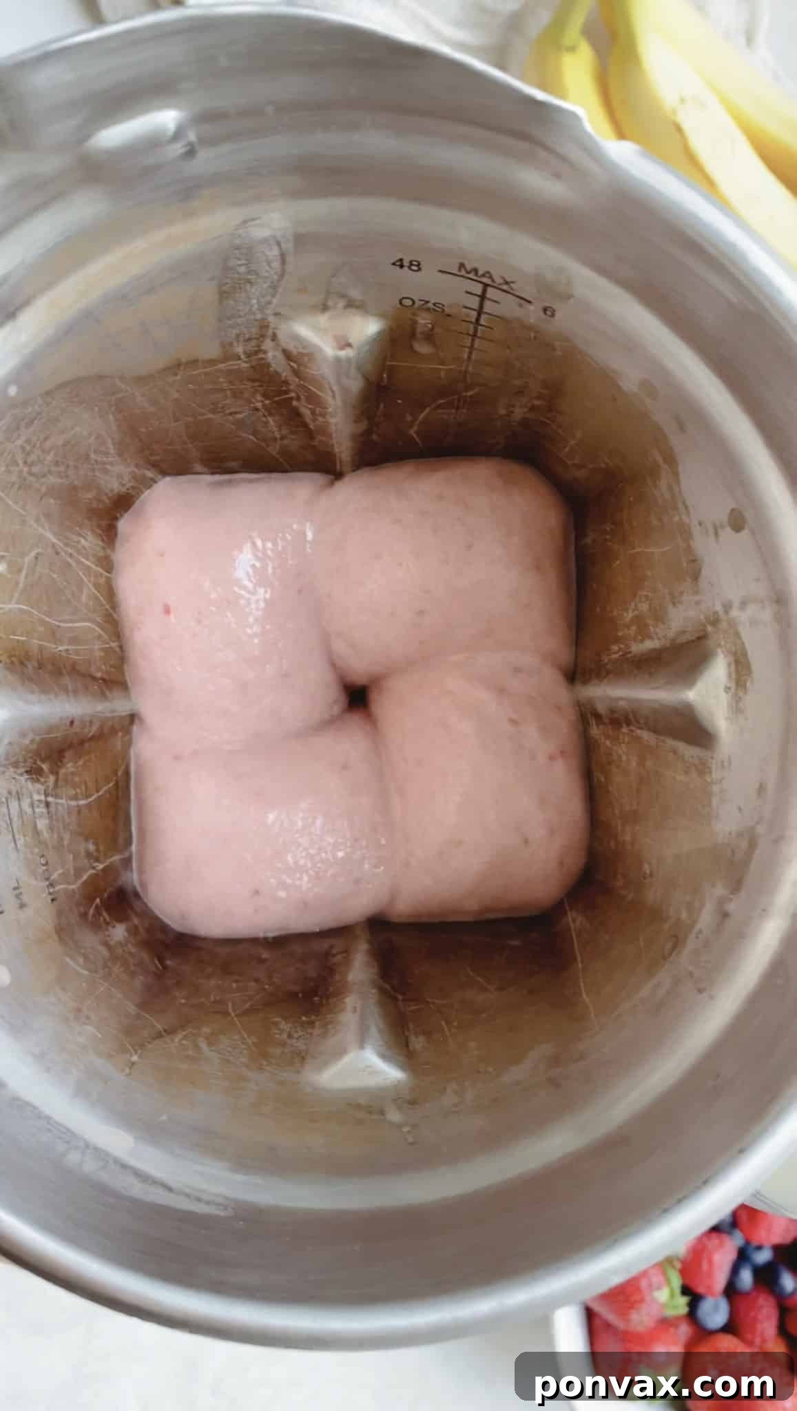 Ingredients being blended in a high-speed blender for a Strawberry Banana Smoothie Bowl.