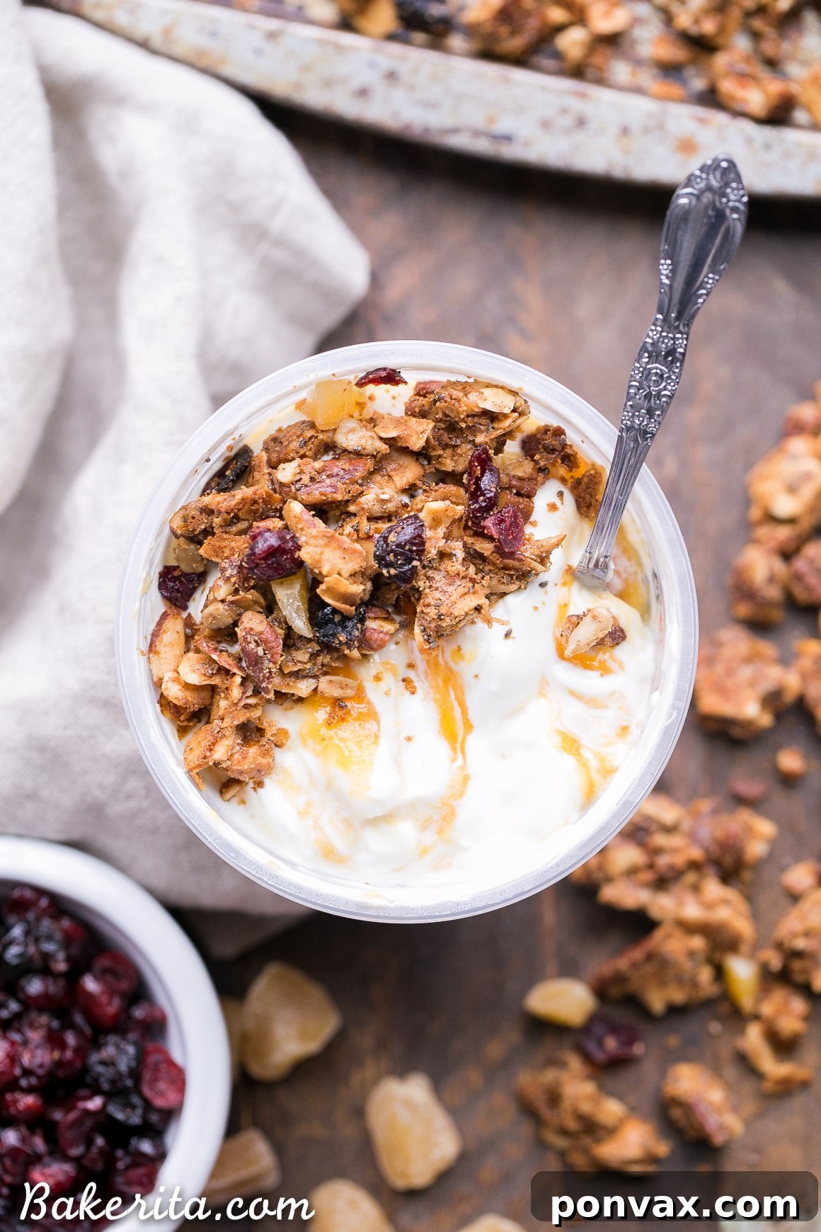 Paleo Vegan Grain-Free Orange Ginger Granola 7 A bowl of orange ginger grain-free granola served with creamy yogurt and fresh berries.