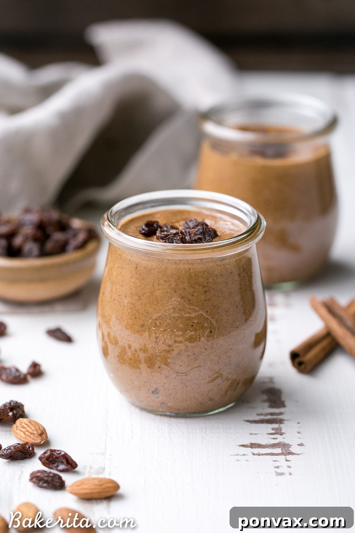 Close-up of creamy Cinnamon Raisin Almond Butter in a jar.