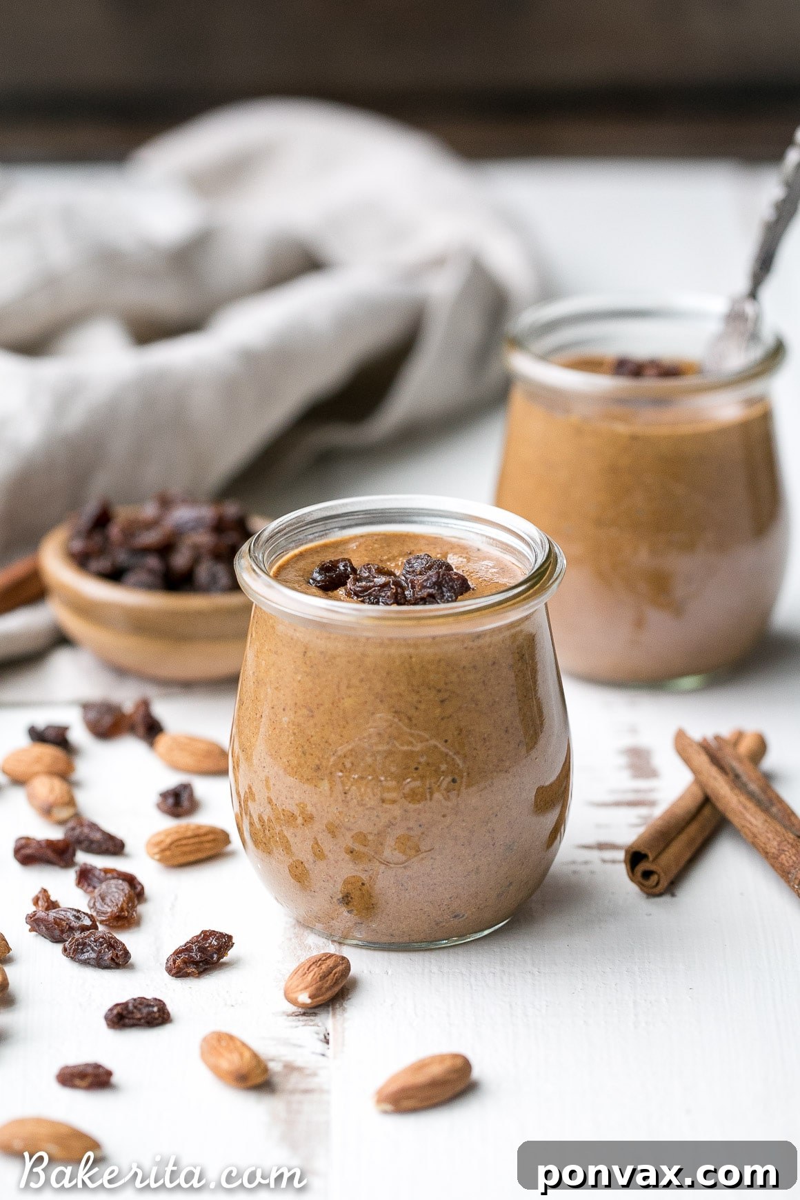 The process of making Cinnamon Raisin Almond Butter in a food processor.