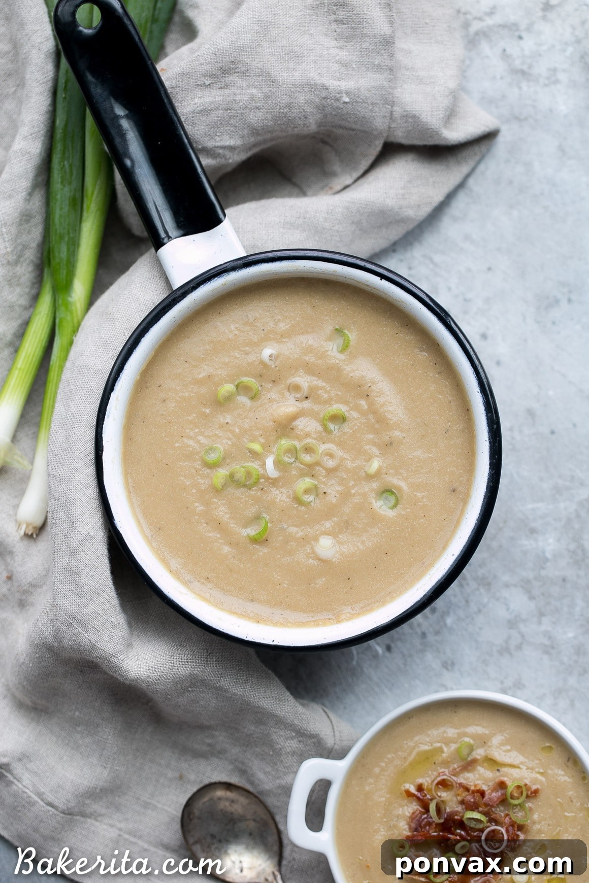 Overhead shot of Cauliflower Leek Soup in a bowl, with a side of toasted bread.