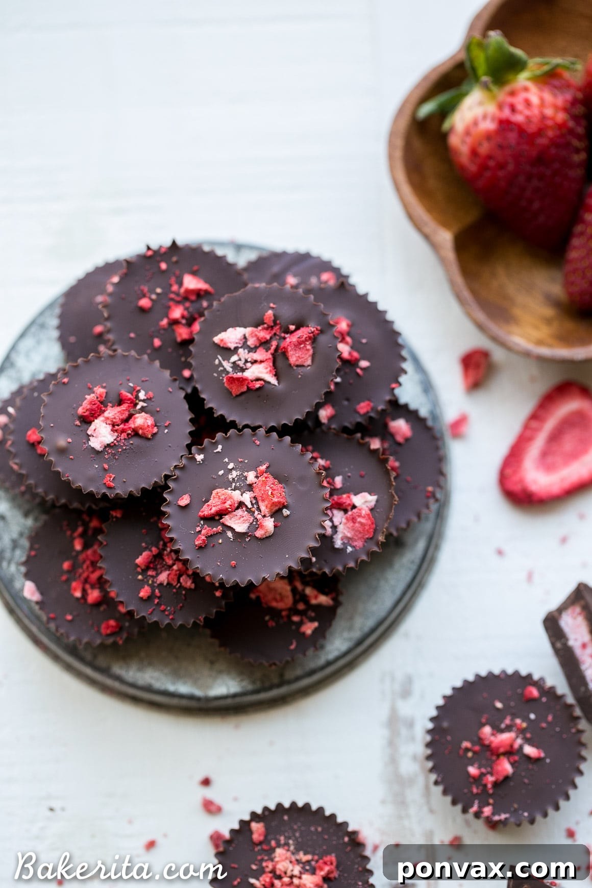 Close-up of a chocolate strawberry cup, revealing the creamy strawberry coconut butter filling inside its dark chocolate shell. Perfect for a healthy dessert.