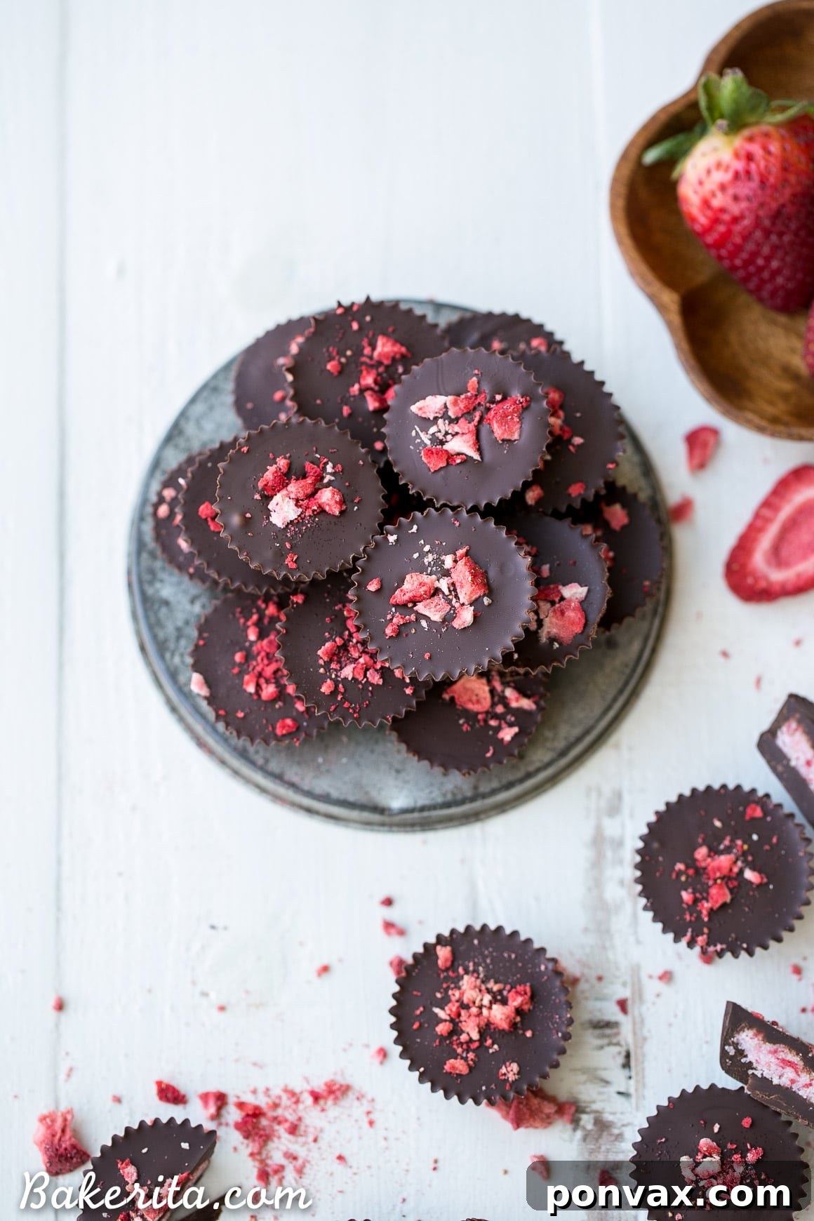 Two hands holding a stack of freshly made chocolate strawberry cups, ready to be enjoyed. A testament to easy and healthy homemade treats.