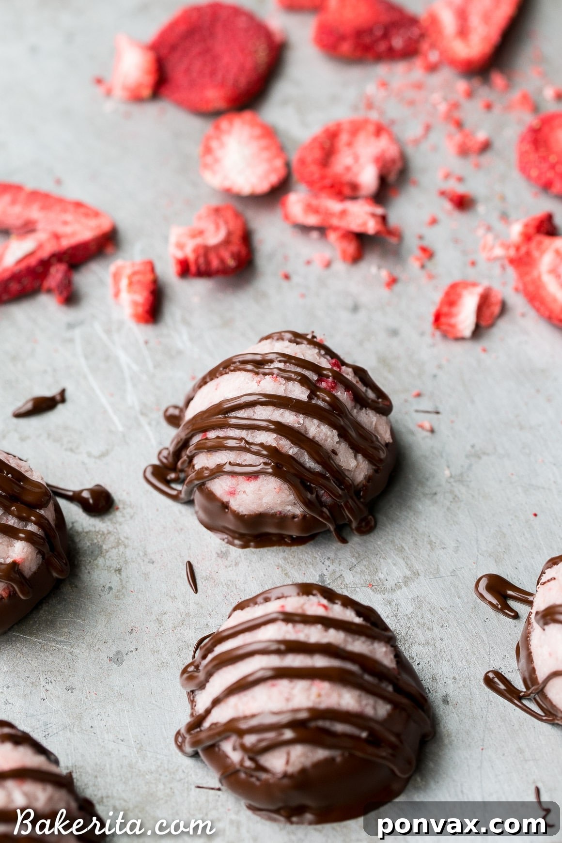 No Bake Vegan Chocolate Covered Strawberry Macaroons 3 Close-up of a perfectly formed No-Bake Chocolate Dipped Strawberry Macaroon, highlighting its vibrant color and smooth chocolate coating.