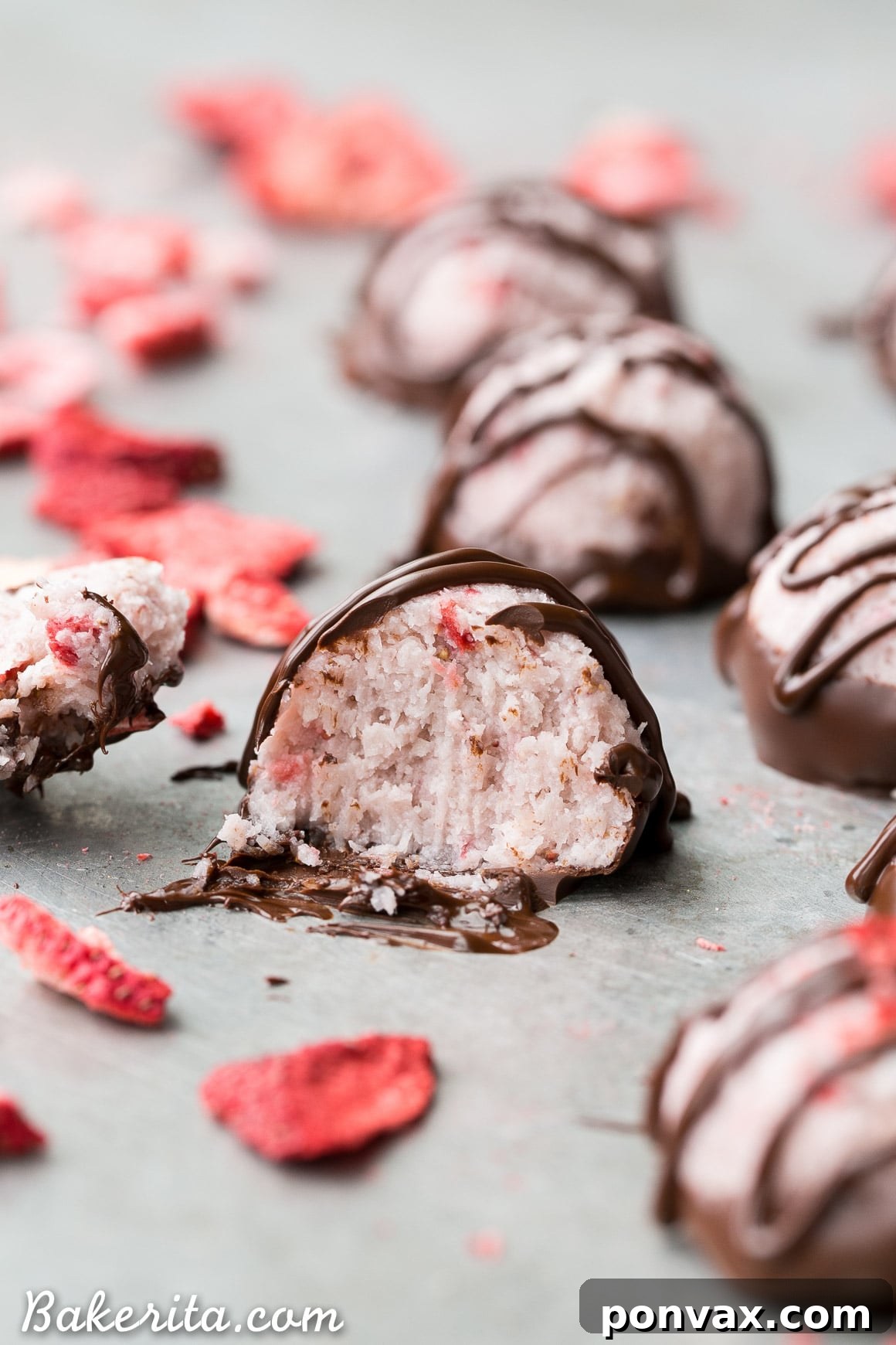 No Bake Vegan Chocolate Covered Strawberry Macaroons 7 Overhead view of several No-Bake Chocolate Dipped Strawberry Macaroons, highlighting their perfect round shape and appealing presentation.