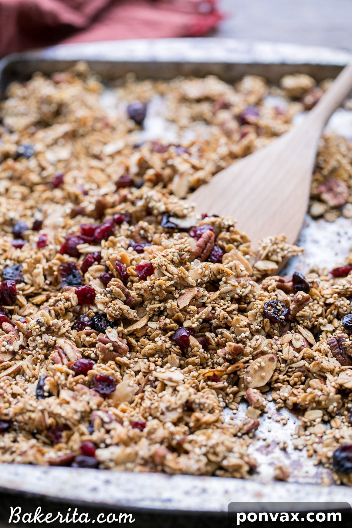Wholesome Vegan Gluten Free Quinoa Granola 4 A vibrant bowl of Quinoa Granola mixed with fresh fruit and yogurt, emphasizing a healthy breakfast option.