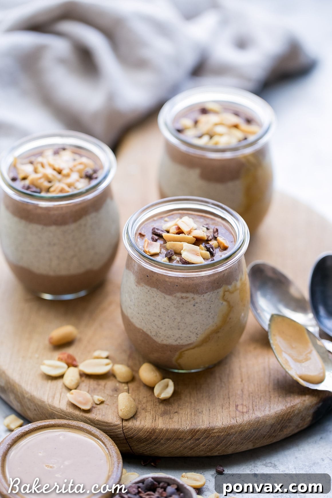 A spoonful of Chocolate Peanut Butter Chia Pudding, showing the creamy texture and inviting layers, with a blurred background of the full jar.