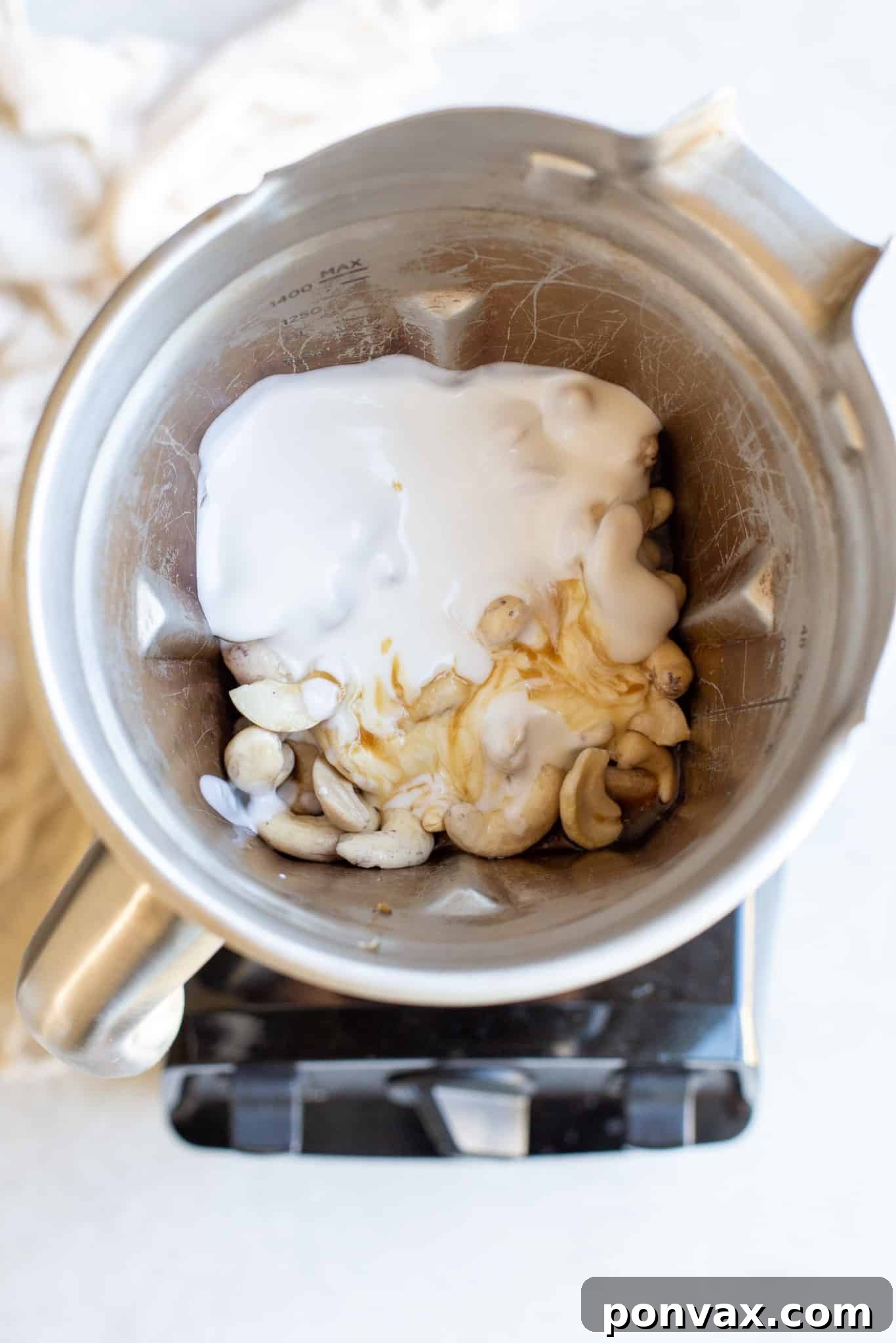 Close-up of a no-bake layered blueberry vegan cheesecake, showing the fluffy vanilla and vibrant blueberry layers.