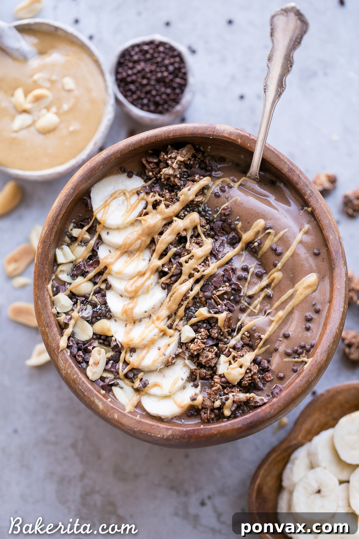 A beautifully arranged Chocolate Peanut Butter Smoothie Bowl topped with banana slices, granola, and a peanut butter drizzle, showcasing its creamy texture and rich colors.