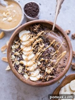 This Chocolate Peanut Butter Banana Smoothie Bowl tastes like a peanut butter cup, but it's actually a filling, superfood-packed breakfast that comes together in just 5 minutes! This gluten-free + vegan smoothie bowl is the perfect way to start the day.