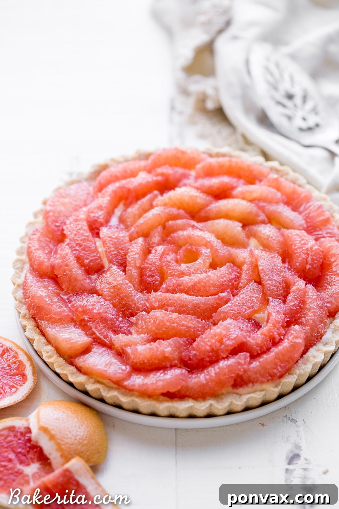 A close-up of a perfectly sliced Grapefruit Tart revealing its creamy curd and sturdy, textured crust.