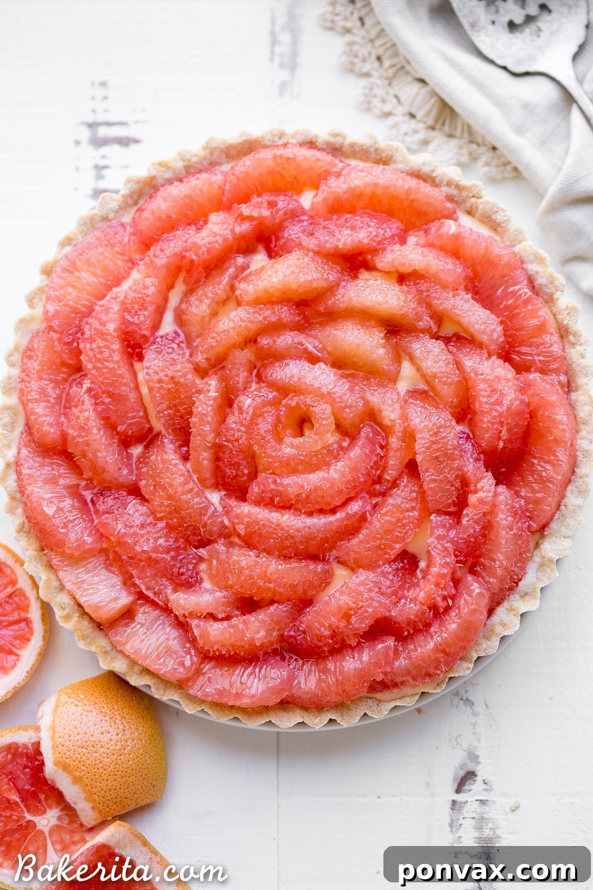 A delectable section of the completed Grapefruit Tart, showcasing the vibrant segments and luscious, creamy curd.