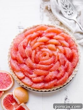 Grapefruit Tart with a bright, tart grapefruit flavor from the silky grapefruit curd, topped with gorgeous pink grapefruit segments. Gluten-free, Paleo, and refined sugar free.