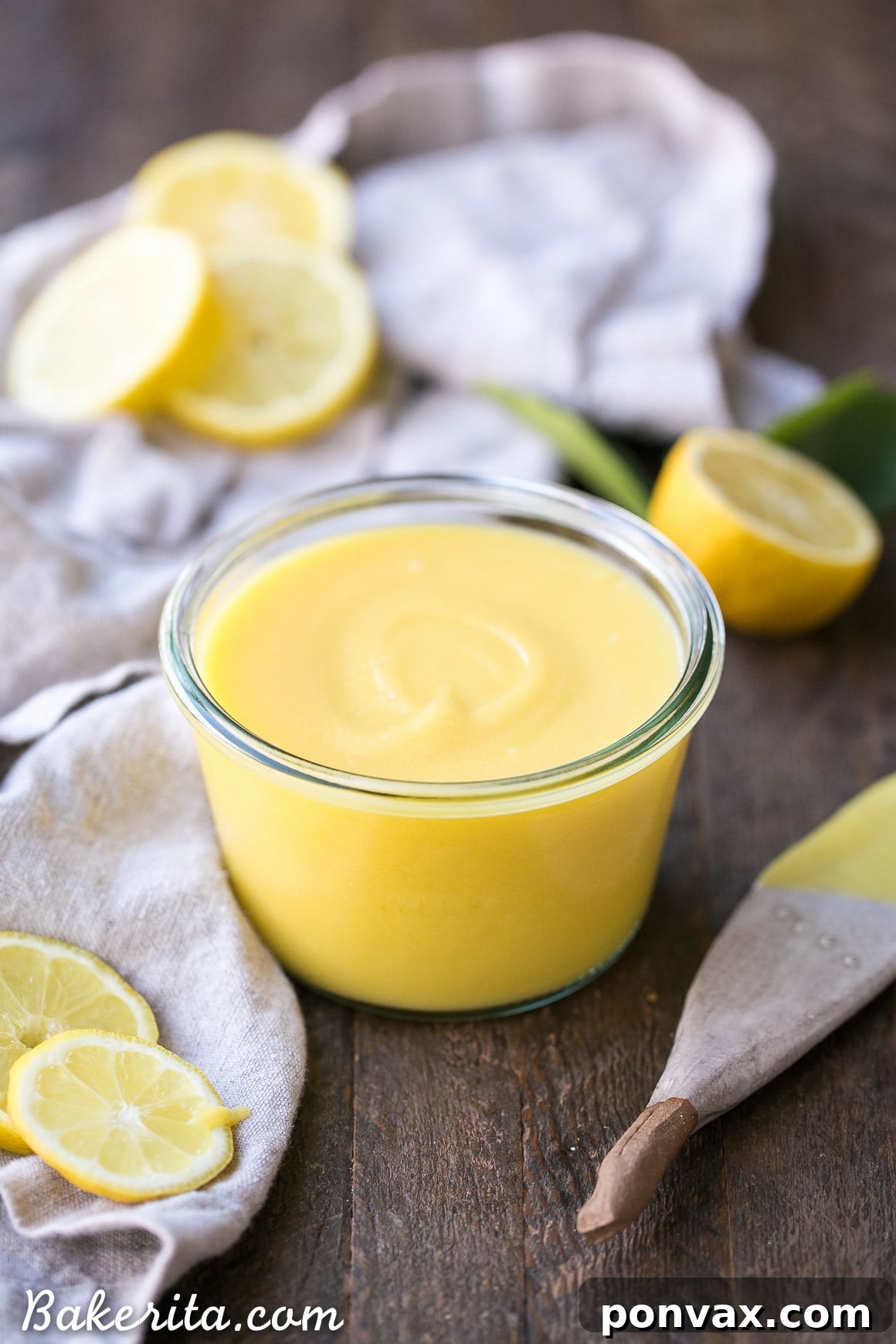Fresh lemons, golden honey, and other high-quality ingredients for Paleo Lemon Curd beautifully arranged on a rustic kitchen counter, ready for preparation.