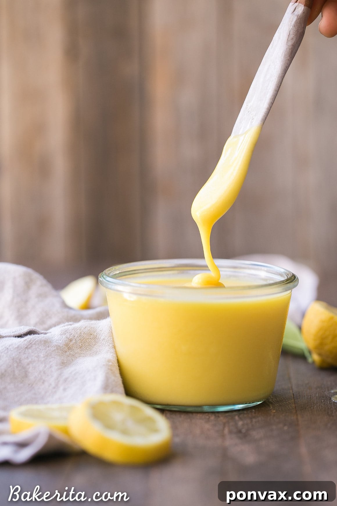 A collection of the five essential ingredients for Paleo Lemon Curd: bright yellow lemons, a jar of golden honey, fresh brown eggs, and a small container of ghee, ready for the recipe.