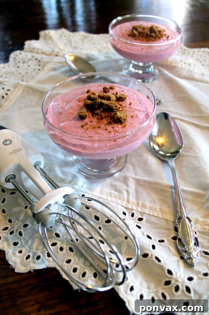 The OXO Good Grips Egg Beater, a manual kitchen tool for whipping ingredients, demonstrating its ergonomic design and sturdy beaters.