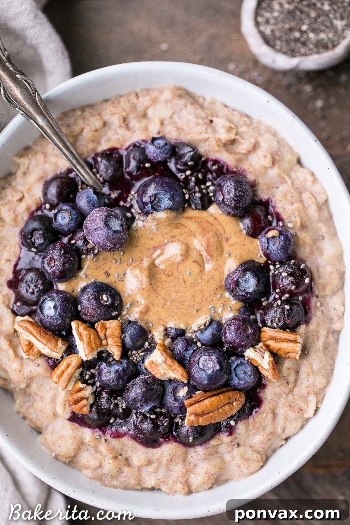 Close-up shot of blueberry compote simmering on a stovetop, ready to top oatmeal.