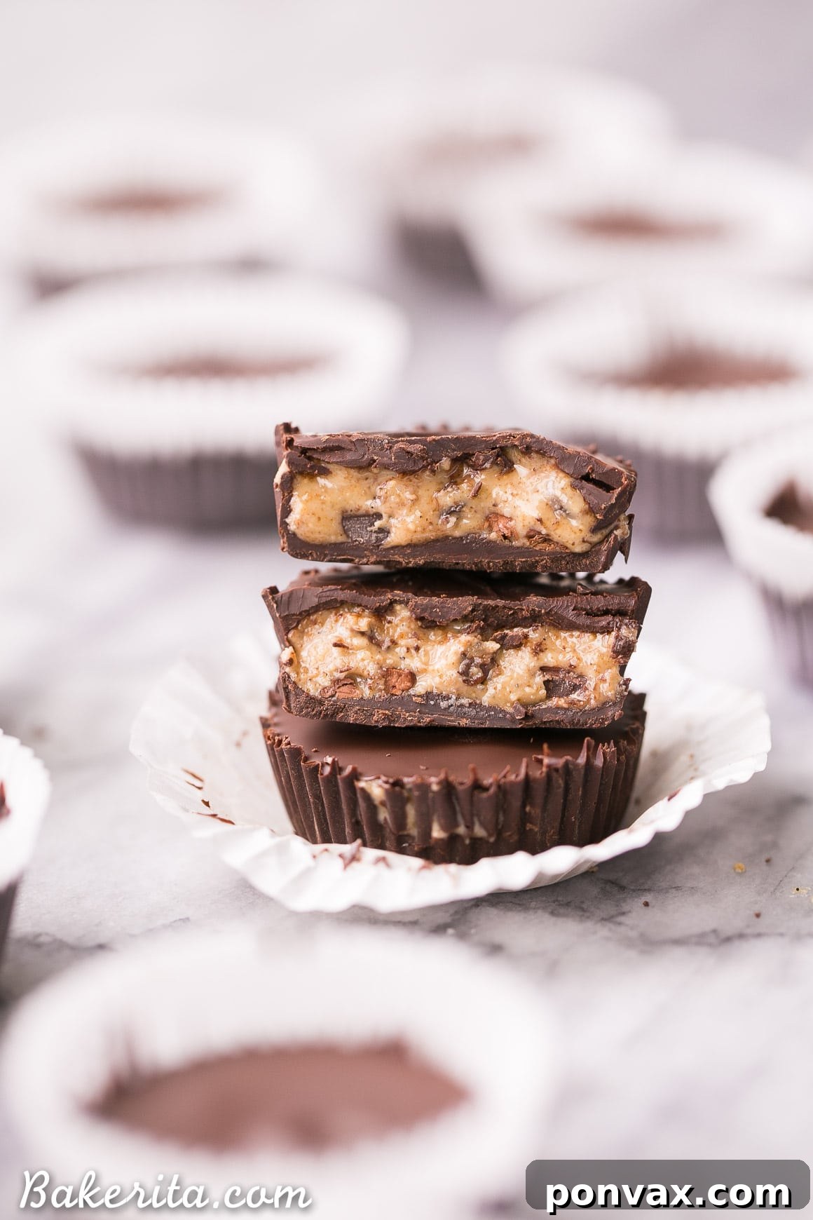Decadent Chocolate Chip Dough Cups 5 Freshly made chocolate chip cookie dough cups hardening in a mini muffin tin, showing the smooth chocolate shell and delicious filling. Vegan and gluten-free.