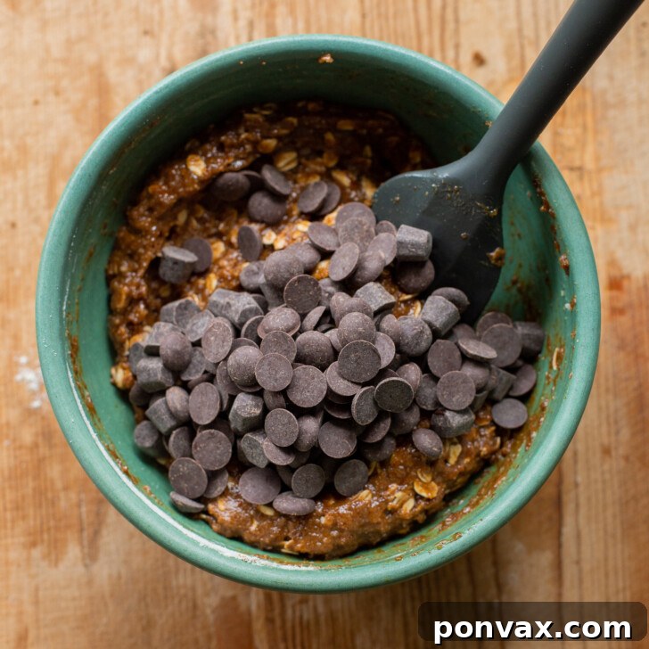 Gluten-Free Oatmeal Chocolate Chip Skillet Delight 12 Image showing chocolate chips being folded into the cookie dough.