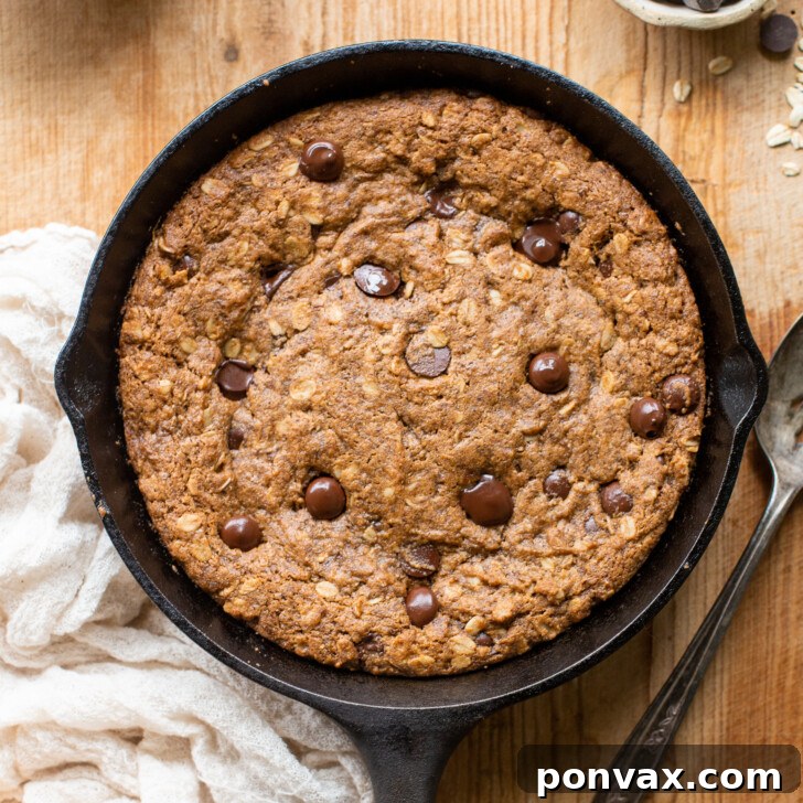 Gluten-Free Oatmeal Chocolate Chip Skillet Delight 15 Image showing the Gluten-Free Vegan Oatmeal Chocolate Chip Skillet Cookie baking in the oven, with a golden-brown crust.
