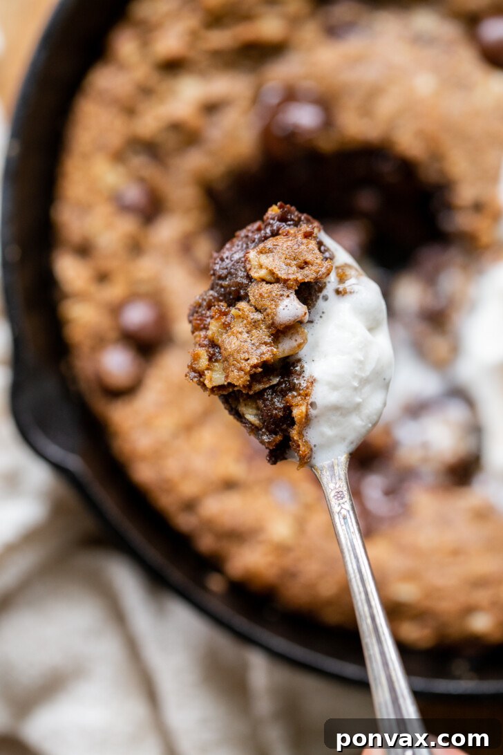 Gluten-Free Oatmeal Chocolate Chip Skillet Delight 16 A beautifully baked Gluten-Free Vegan Oatmeal Chocolate Chip Skillet Cookie with perfectly melted chocolate, ready to be served.