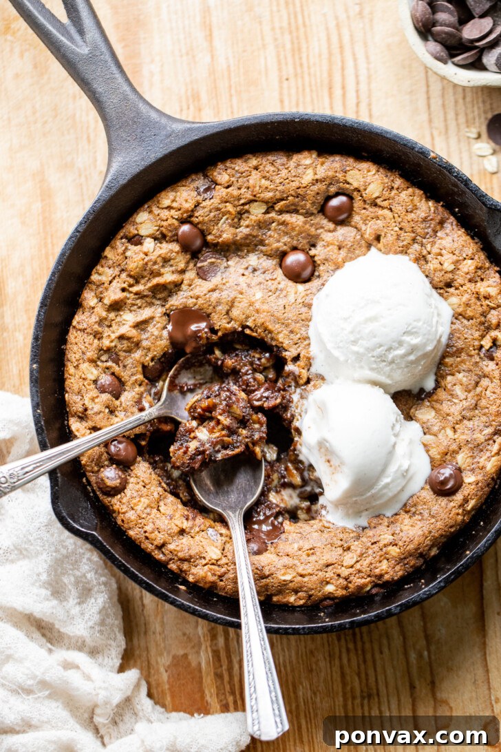 Gluten-Free Oatmeal Chocolate Chip Skillet Delight 18 A final shot of the Gluten-Free Vegan Oatmeal Chocolate Chip Skillet Cookie with a spoon, inviting you to dig in.