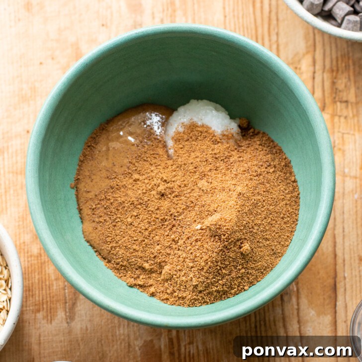 Gluten-Free Oatmeal Chocolate Chip Skillet Delight 6 Image showing coconut oil, nut butter, and coconut sugar being mixed together.