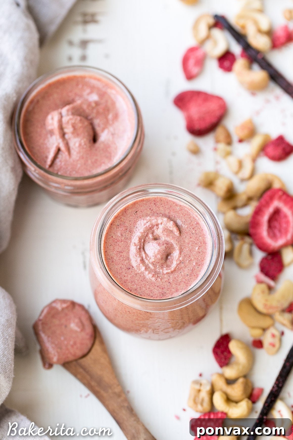 A close-up shot of creamy Strawberry Cashew Butter being swirled in a food processor, highlighting its smooth texture.