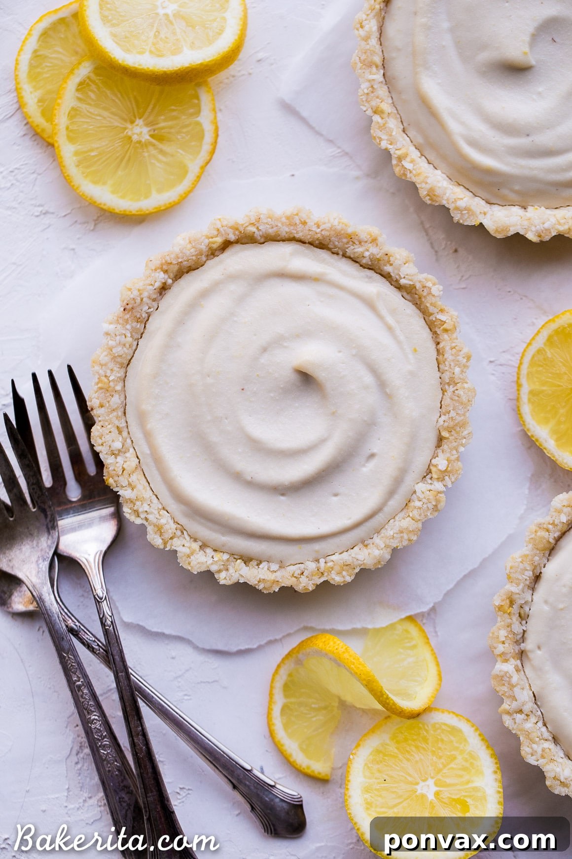 Creamy Vegan No-Bake Lemon Tarts 6 A row of mini No-Bake Lemon Tarts on a cooling rack, freshly prepared and awaiting chilling.