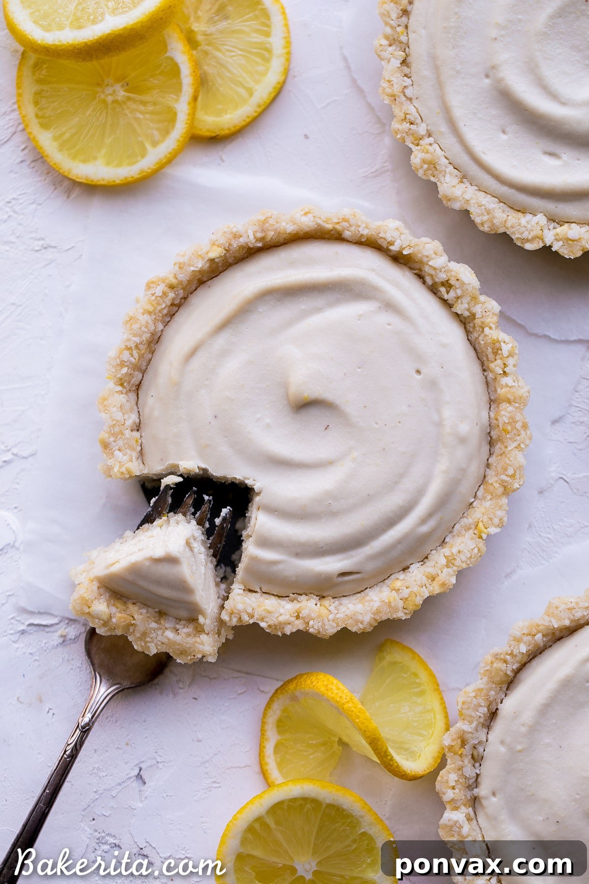 Creamy Vegan No-Bake Lemon Tarts 7 A whole No-Bake Lemon Tart on a white plate, showcasing its golden crust and smooth lemon filling.