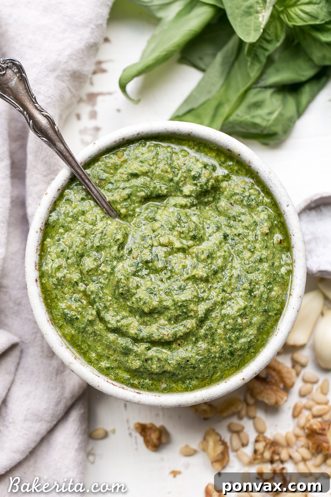 This Spinach Basil Pesto is loaded with bright herby flavor and made in just a few minutes. You won't miss the cheese in this paleo, vegan + Whole30-friendly pesto. It will make any meal more flavorful, whether it's tossed with pasta, enjoyed with your favorite protein, or used as a spread.