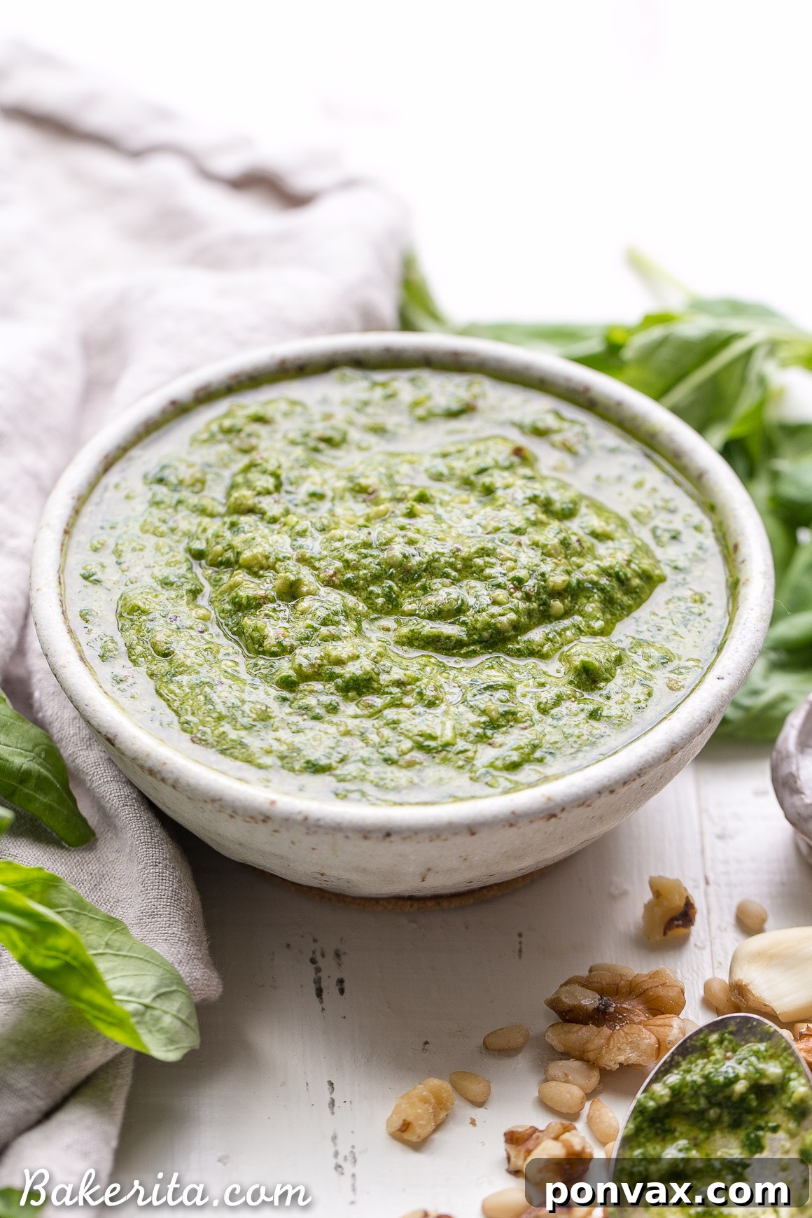 This Spinach Basil Pesto is loaded with bright herby flavor and made in just a few minutes. You won't miss the cheese in this paleo, vegan + Whole30-friendly pesto. It will make any meal more flavorful, whether it's tossed with pasta, enjoyed with your favorite protein, or used as a spread.